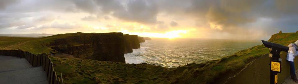 A beautiful sunset with 400 foot cliffs above the Atlantic Ocean, located at the Cliffs of Moher in Ireland
